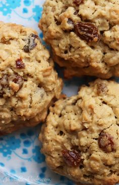 four oatmeal cookies on a blue and white plate