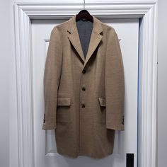 This Was Purchased New At Brooks Brothers And Worn Just A Few Times. This Is A Beautiful, Well Made Coat And Is In Like New Condition. The Coat Is Perfect Spring Weight Coat And Does Not Have A Heavy Inner Lining. It Has Beautiful Stitching And Is Buttery Soft. Timeless Style, Quiet Luxury! All Items Are Authentic And Were Purchased Brand New Directly From The Manufacturer Or A Department Store Like Neiman Marcus, Nordstroms, Etc. If I Have The Receipt A Photo Will Be Posted, Otherwise I Don’t H Semi-formal Beige Wool Outerwear, Designer Brown Notch Lapel Outerwear, Luxury Beige Single Breasted Outerwear, Luxury Beige Single-breasted Outerwear, Designer Business Casual Outerwear With Welt Pockets, Designer Outerwear With Welt Pockets For Business Casual, Beige Semi-formal Winter Outerwear, Designer Brown Outerwear For Semi-formal Occasions, Designer Semi-formal Brown Outerwear