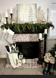 a fireplace decorated for christmas with stockings and candles