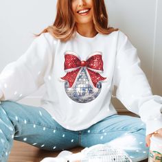 Hey there, holiday disco queen! Bring some sparkle to your festive wardrobe with our "Disco Christmas Bow" Graphic Sweatshirt. Featuring a fun, dazzling bow designed with disco shimmer, this sweatshirt adds a groovy twist to your holiday style. Crafted from ultra-soft, cozy fabric, it’s perfect for keeping you warm and comfortable during all your holiday activities—from tree trimming to dancing at holiday parties. The eye-catching design combines festive flair with disco vibes, making it the ultimate statement piece this season. Pair it with jeans or leggings for a fun and festive outfit that’s ready to dazzle. Shine bright and get your groove on with this unique holiday sweatshirt! 🎀✨ Designs are printed with direct to garment, high quality ink. Holiday Snacks, Holiday Sweatshirt, Bow Design, Christmas Bows, Holiday Activities, Large White, Holiday Fashion, Festival Outfits, Statement Pieces