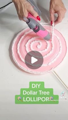 someone is making a pink and white cake