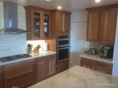 a kitchen with wooden cabinets and stainless steel appliances