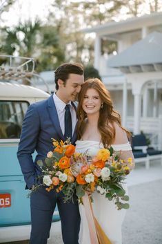 a bride and groom standing next to an old vw bus with flowers in their bouquets