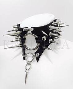 Black leather choker with spikes is designed to make a statement! This choker features a stunning combination of spikes, measuring 40mm, 25mm, and 10mm in height.  Crafted from high-quality black leather, it exudes a badass vibe that's sure to turn heads. The choker is equipped with a convenient roller clasp, ensuring a secure and comfortable fit around your neck.  Adding a touch of charm is a petite acrylic spike charm, measuring 24mm in length.  This badass collar is a perfect match for any al Cute Goth Accessories, Chockers Ideas, Spiked Collar Outfit, Rope Outfit, Human Collar, Spiky Choker, Spiked Choker Aesthetic, Punk Metal Choker For Alternative Fashion, Rib Cage Chain Harness