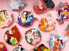 there are many disney pin badges on the pink surface, including princesses and pooh