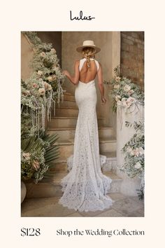 a woman in a white dress and hat is standing on the stairs with her back to the camera