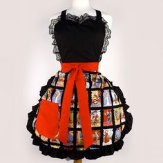 a woman's apron with pictures on it and an orange ribbon around the waist