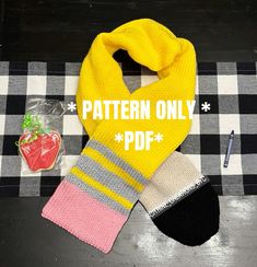 a yellow scarf with the words pattern only on it next to some candy and a strawberries