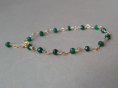 A beautiful, minimalist bracelet with deep green emerald rondelles Please measure tightly your wrist's circumference, using a ribbon or something similar, and then measuring the ribbon with a ruler. When ordering, please select the actual wrist size, not the size of the bracelet. I will make the bracelet fit your wrist, by adding approx 0.6 inch to the circumference. The bracelet was set up using gold filled wire and genuine emerald faceted rondelles. Available also with rose gold filled  or sterling silver findings. The bracelet is adjustable.  The listed gemstones can be replaced with others of your choice;  please convo me for custom orders.  Emerald is a stone of great harmony, wisdom and love, domestic bliss, sensitivity, loyalty, memory, mental capacity, harmony, focus, eliminating n Adjustable Green Emerald Bracelet, Green Onyx Bracelets - Gift, Faceted Beads Bracelets As May Birthstone Gift, May Birthstone Spacer Beads Jewelry Gift, Faceted Beads Bracelet For May Birthstone Gift, Green Rondelle Bracelets For Jewelry Making, May Birthstone Bracelets With Faceted Beads As Gift, Gift Jewelry With Spacer Beads For May Birthstone, Elegant May Birthstone Beaded Bracelets With Faceted Beads