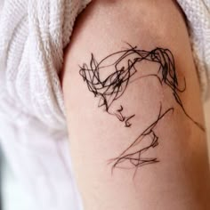 a woman's arm with a tattoo on it that looks like she has long hair