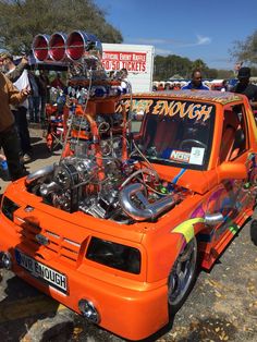 an orange truck with engine on the hood