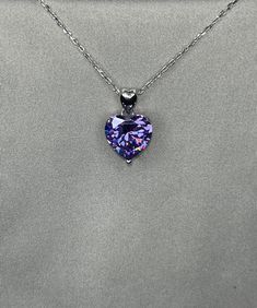 "A beautiful purple shaded necklace that is sure to get lots of attention. Makes a great gift, arrives in a wrapped gift box. 5 Ct. Heart-Cut Moissanite Diamond Purple Sapphire Bridal Necklace 925 Sterling Silver Chain Size : 18 \" (45.7 cm) including the clasp Pendant Size : 1.2 cm (5 Carat) Main Stone Color : Purple Main Stone: Moissanite Topaz Main Stone Shape : Heart Cut Metal : Real Solid 925 Sterling Silver Hallmark : 925 Stones Setting : Prong Finish : Fine Polished Guaranteed High Qualit Formal Heart Cut Birthstone Necklace, Purple Sterling Silver Heart Cut Necklace, Purple Heart Cut Sterling Silver Necklace, Purple Heart-cut Sterling Silver Necklace, Sterling Silver Purple Heart Pendant Necklace, Purple Sterling Silver Heart Pendant Necklace, Heart Cut Amethyst Necklace For Anniversary, Elegant Heart-shaped Amethyst Necklace, Heart Cut Amethyst Necklaces For Anniversary