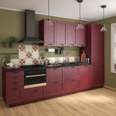 a kitchen with wooden floors and red cabinets