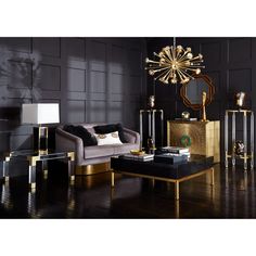 an elegant living room with black walls and gold accents