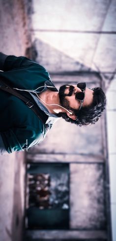 a man with sunglasses on his head is looking up at the ceiling and listening to music