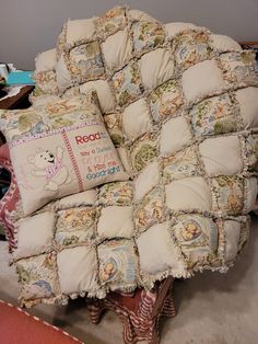 a chair with pillows on it and a pillow that is made to look like a quilt