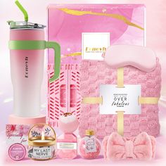 the contents of a pink gift set including a sleeping mask, travel mug and other items