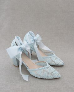 "Classic and elegant lace almond toe block heel with ballerina lace ups. Perfect for weddings, parties, or any special occasion. DETAILS: HEEL HEIGHT: 2.75 inches COLORS AVAILABLE: Ivory, White and Light Blue UPPER: Synthetic upper and lining MATERIALS: Manmade outsole STYLE NAME: ABBY SIZE FIT: RUNS LARGE Not sure of which size to purchase? Shoes measurements are as follow: (Please note measurements taken the length of inside of shoe from toe to heel) SIZE 5 - 9.25\" SIZE 6 - 9.75\" SIZE 7 - 10 Light Blue Bridal Shoes, Lace Heels With Round Toe And Laces, Lace Heels With Laces And Round Toe, Lace-up Lace Heels, Fitted Lace Wedding Shoes For Spring, Lace Wedding Shoes For Bridesmaids, Lace-up Lace Wedding Shoes For Formal Occasions, Formal Lace Wedding Shoes With Lace-up Design, Fitted Lace-up Lace Wedding Shoes