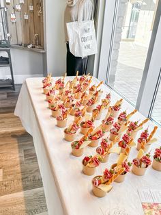 a table topped with lots of small cups filled with food