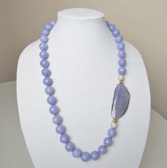 Single strand purple beads with large purple agate accented with pave beads Elegant Purple Necklace With Large Beads, Elegant Purple Agate Beaded Necklaces, Elegant Purple Agate Beaded Necklace, Purple Agate Gemstone Beaded Necklace, Elegant Purple Faceted Beads, Elegant Lavender Beaded Necklace With Natural Stones, Elegant Large Purple Beads, Elegant Lavender Beaded Necklace With Polished Beads, Elegant Lavender Polished Beaded Necklaces