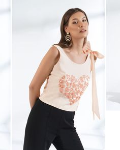 ▶ ABOUT THE TOP: This ivory crepe top is a statement of style. Hand embroidered with sequin in shape of small hearts and a big statement organza bow. Perfect for a day out at the office or a casual brunch with your friends. Made from 100% pure crepe fabric, the top has a regular fit and we offer it in plus sizes up to 5XL. ▶ ITEM DETAILS: * Top made with pure crepe * The model is 5'7 tall and wearing size M. * Handmade item, crafted to perfection. * The length of the top is 19 inches ▶ FABRIC: * Elegant Embellished Cotton Blouse, Chic Party Tops With Floral Embroidery, Chic Floral Embroidery Party Top, Fitted Feminine Embroidered Top, Chic Floral Embroidered Party Top, Chic Floral Embroidery Top For Evening, Chic Evening Tops With Floral Embroidery, Sleeveless Cotton Sequin Top, Embroidered Sleeveless Evening Blouse