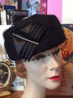 "Vintage 1950s 1960s Black 100% Wool hat . Has Black veiling covering the hat. Rhinestones adorning the right side. The label is: Linda Farrell New York. CONDITION : Has a small split in the veiling. (SEE PIX). MEASURES: Inside circumference-22\" Height-4\" **WE APOLOGIZE~BUT WE CAN NO LONGER SHIP TO ITALY OR SPAIN. WE HAVE INCURRED TOO MANY ISSUES WITH SHIPPING. PACKAGES GOING MISSING..DAMAGED...ETC. IF ORDERS COME IN FROM ITALY OR SPAIN, WE WILL HAVE TO CANCEL THEM AND REFUND YOUR MONEY. SORRY Vintage Black Fascinator For Party, Vintage Fitted Headpieces For Party, Vintage Black Headpieces For Parties, Vintage Cloche Hat With Short Brim For Parties, Vintage Short Brim Party Hats, Vintage Fitted Cloche Hat For Party, Vintage Brimmed Cloche Hat For Party, Vintage Cloche Costume Hat For Party, Vintage Costume Hats And Headpieces For Events