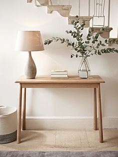 a table with two baskets and a lamp next to it