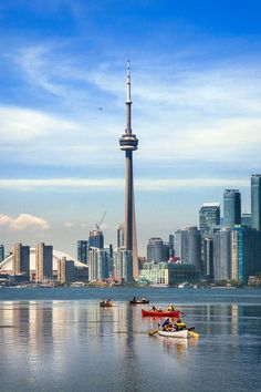 the city skyline is reflected in the water