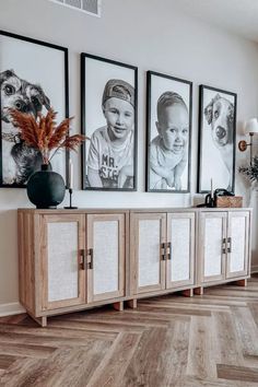 a living room with pictures on the wall and wood flooring in front of it