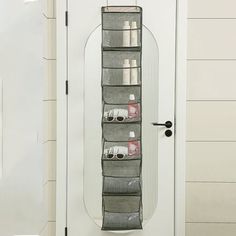 an over the door hanging organizer in front of a white door with a glass door