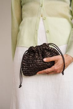 a woman is holding a bag in her hands