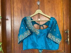 Hand embroidered ready made saree blouse / crop top/stitched saree blouse usa / saree blouse/modern blouse/zardosi blouse/blue saree blouse/ pure silk blouse/ maggam work blouse / white blouse        It is very true that a perfect blouse is the one which makes your saree look stand out !! If you find one of such a style that you have been wanting to have then dont let it go !! we carry such unique trending blouses that instantly add a stylish look to any saree !!     Well..!! we understand that you may not get in your desired size/pattern, here you go with customization according to your size/pattern which we can deliver in 1-2 weeks of time period !!      Here is a beautiful Hand embroidered saree blouse/ crop top  in sea green color that has embossed multi embroidery on sleeves and neck Fitted Blue Tissue Silk Blouse Piece, Navratri Tissue Silk Blouse Piece With Floral Embroidery, Fitted Silk Saree With Handwork, Traditional Silk Tops With Handwork, Fitted Blue Tissue Silk Choli, Semi-stitched Tissue Silk Blouse With Floral Embroidery, Chanderi Blouse With Dori Work For Reception, Fitted Dola Silk Top With Handwork, Dola Silk Top With Traditional Drape For Reception