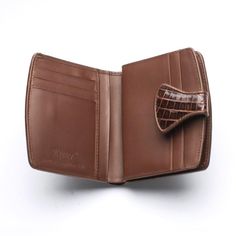 River twotone dark brown genuine crocodile tail skin leather wallet ~ new    Favour timeless leather goods and choose our TwoTone Brown Crocodile Skin Women's Wallet. Crafted to last, this understated walled exudes a demure elegance that everyone will notice. We use high-grade crocodile leather and celebrate all of its unique markings with a two-tone brown dye.      This picks up on all the intricate wrinkles and scales across the body, while also allowing it to pair effortlessly with the other Elegant Brown Trifold Wallet With Leather Lining, Brown Business Wallets With Crocodile Pattern, Leather Bifold Wallet With Crocodile Pattern, Brown Crocodile Pattern Business Wallet, Elegant Brown Textured Leather Wallet, Classic Leather Wallet With Crocodile Pattern, Formal Brown Wallet With Crocodile Pattern, Formal Leather Wallets With Crocodile Pattern, Formal Crocodile Pattern Leather Wallets