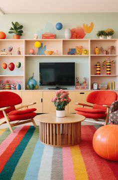 a living room filled with furniture and a flat screen tv mounted on a wall above a colorful rug