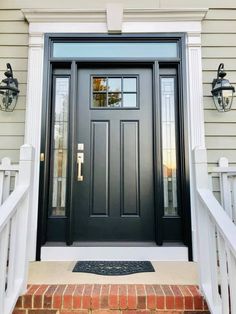 a black front door on a white house