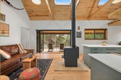 a living room filled with furniture and a fire place in the middle of a kitchen