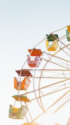 the ferris wheel is brightly colored and empty