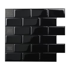 black glass tile with white lettering on the bottom and side panels in different shapes, sizes and colors