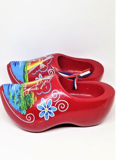 "Vintage Holland Shoes, Souvenir Shoes, Dutch Clogs, Red Holland Shoes, Floral Windmill, Holland Shoes, Klompenfabriek, Wooden Shoes Perfect collectible from Holland. Display piece. Very Colorful Dutch souvenir. Red Holland Clogs. Hang on the wall and fill with florals or greenery sprigs! Measures: 6\" long x 3\" wide each. Condition: Very good, Marked \"Holland\" near windmill. Please visit our shop to view our entire vintage selection at DartmouthHill: https://www.etsy.com/shop/DartmouthHill?r Dutch Shoes, Dutch Clogs, Red Clogs, Clog Shoes, Costume Shoes, Wooden Shoes, Clogs Shoes, Holland, Clogs