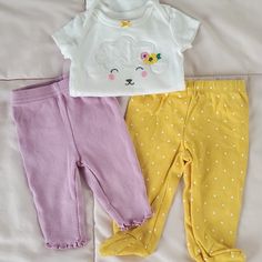 Lamb White Onesie And 2 Pair Of Pants. The Yellow Polka Dot Pants Are Feeties And Were Wore Once. The Purple Were Washed But Never Worn Cute Yellow Bottoms For Playwear, Playful Yellow Cotton Bottoms, Playful Yellow Cotton Pants, Yellow Bottoms For Playtime In Spring, Playful Yellow Bottoms For Playwear, Yellow Bottoms For Spring Playtime, Yellow Cotton Playwear Bottoms, Yellow Cotton Bottoms For Playwear, Cute Yellow Bottoms For Playtime