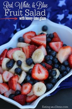 red, white and blue fruit salad with honey - lime glaze in a bowl