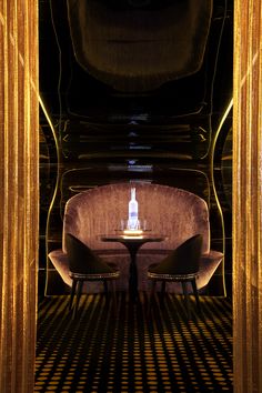 two chairs sitting at a table in a room with gold curtained walls and flooring