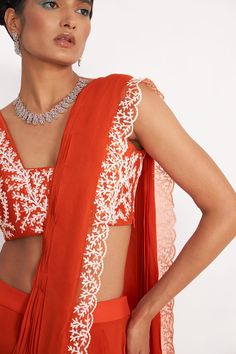 Orange padded blouse with all over leaf embroidery. Comes with pre-draped saree and belt.
Components: 3
Pattern: Embroidery
Type Of Work: Leaf
Neckline: V-neck
Sleeve Type: Sleeveless
Fabric: Saree: Georgette, Blouse: Silk, Lining: Butter Crepe
Color: Orange
Other Details: 
Fitted at bust and waist
Closure: Side zip
Occasion: Wedding - Aza Fashions Saree Georgette, Draped Saree, Embroidery Leaf, Orange Saree, Padded Blouse, Drape Saree, Blouse Silk, Georgette Blouse, Orange Leaf