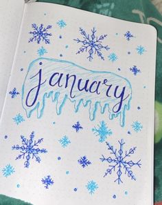 an open notebook with the word january written on it and snowflakes around it