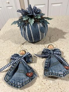 two denim angel ornaments sitting on top of a counter