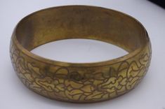 Vintage Gold-tone Bangle, ornate design. In good vintage condition, great one to take on holiday with you. She will come boxed. Vintage Antique Gold Cuff Bangle Bracelet, Vintage Antique Gold Cuff Bangle, Vintage Antique Gold Bangle Cuff Bracelet, Vintage Antique Gold Cuff Bracelet, Vintage Gold Bracelet For Ceremonial Occasions, Antique Gold Stamped Bracelets, Vintage Gold Bracelet With Intricate Design, Vintage Brass Bangle Bracelets, Vintage Brass Bangle Bracelet