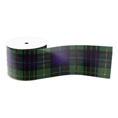 a roll of green and purple plaid ribbon on a white background with a black stripe