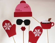 the cupcake pops are decorated with mittens, gloves and snowflakes