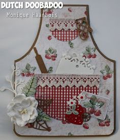 a close up of a card on a table with flowers in the foreground and an image of a kitchen utensil