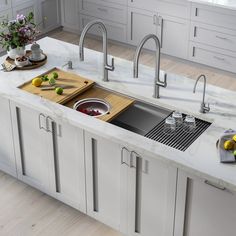 a kitchen with marble counter tops and stainless steel sinks